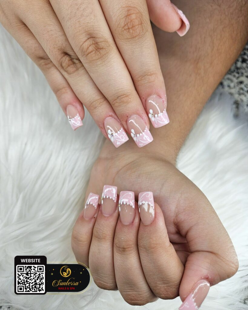 Pink square nails with delicate white floral nail art